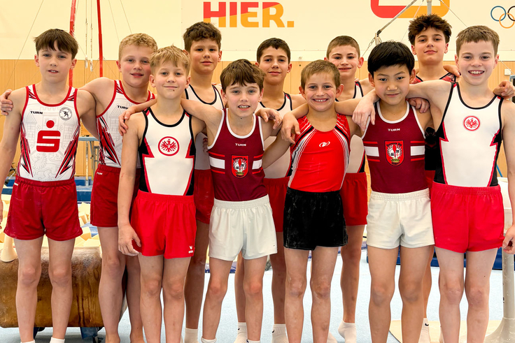 11 Sportler stehen in zwei Reihen für ein Gruppenfoto