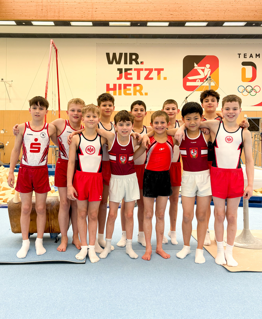 11 Sportler stehen in zwei Reihen für ein Gruppenfoto
