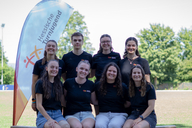Acht junge Menschen posieren für ein Gruppenfoto