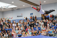 Die Turnerin Maya Möller zeigt Kindern Turnelemente auf dem Mini-Trampolin.