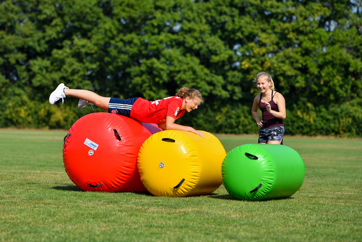Zwei Mädchen spielen auf einer Wiese.
